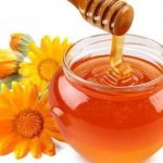 Honey in a jar and flowers
