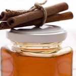 Cinnamon sticks and a jar of honey