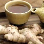 Green tea with ginger with a cup and ginger root